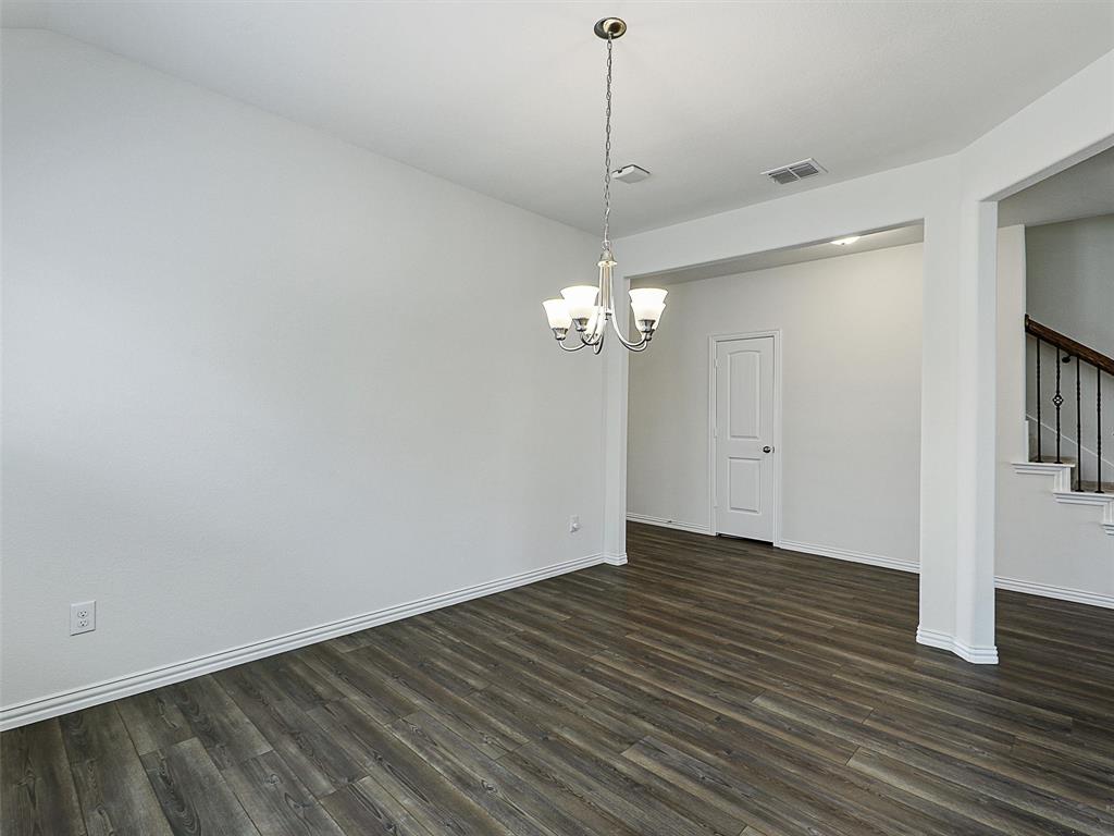 910 Torrey Avenue Princeton, TX 75407 - Photo 8 of 39 a view of empty room with wooden floor