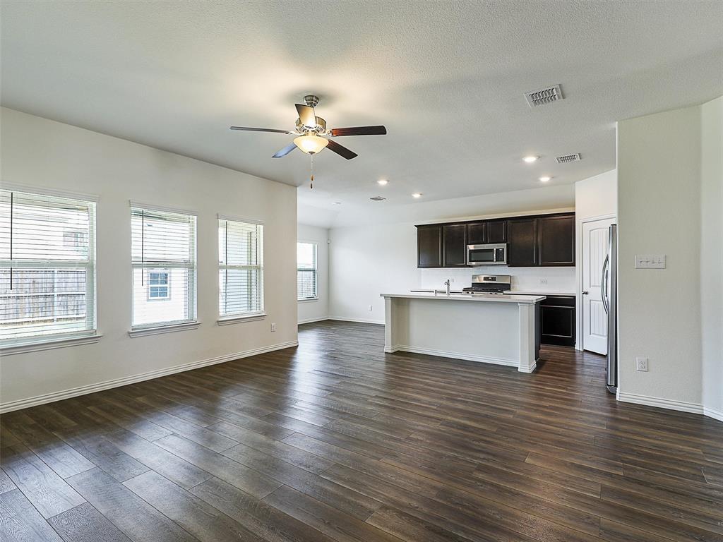 910 Torrey Avenue Princeton, TX 75407 - Photo 10 of 39 a view of kitchen with cabinets stainless steel appliances with wooden floor