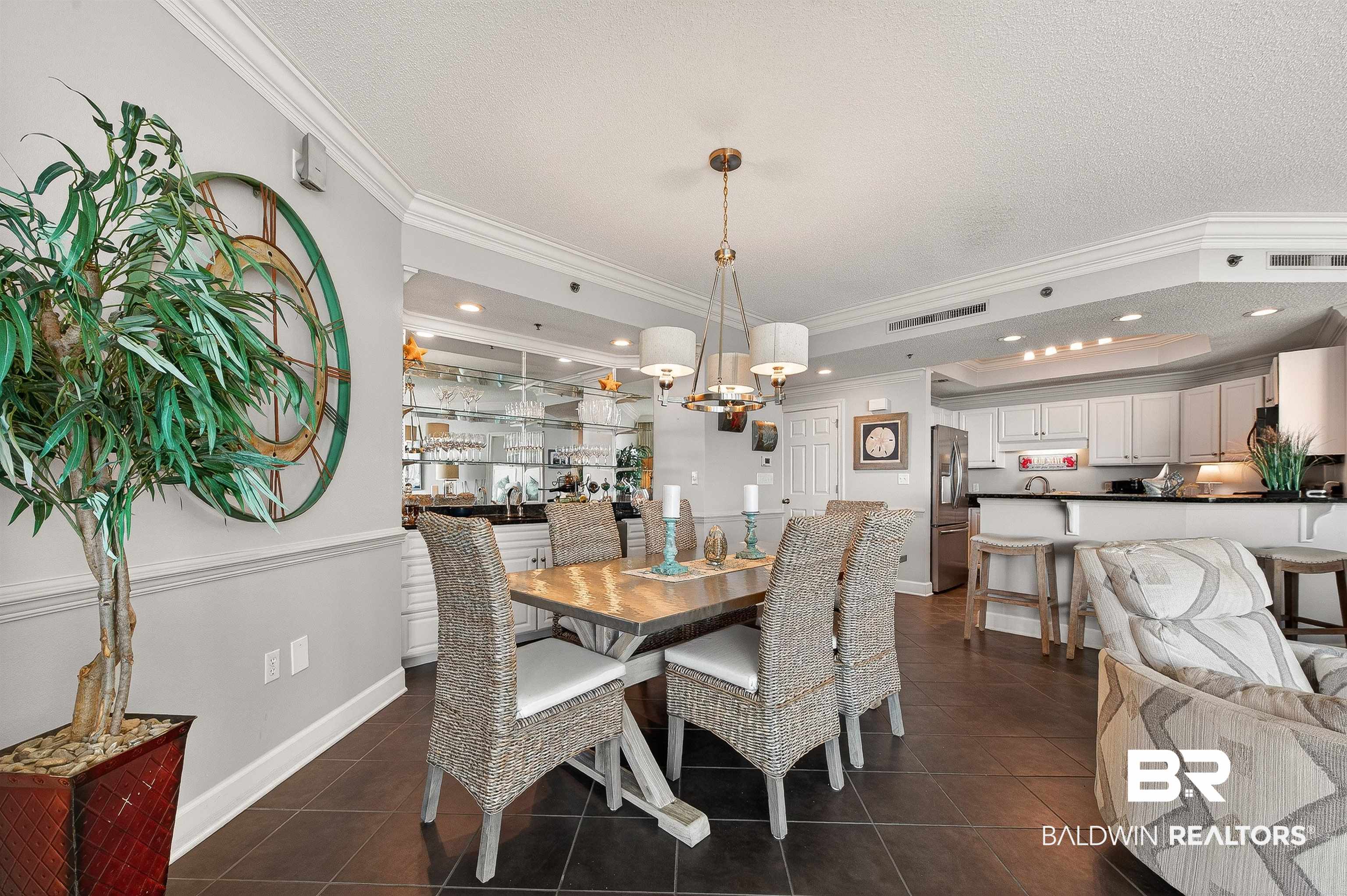 27582 Canal Road, Unit 2507 Orange Beach, AL 36561 - Photo 22 of 75 Dining area featuring ornamental molding, recessed lighting, dark tile patterned flooring, a textured ceiling, and a chandelier