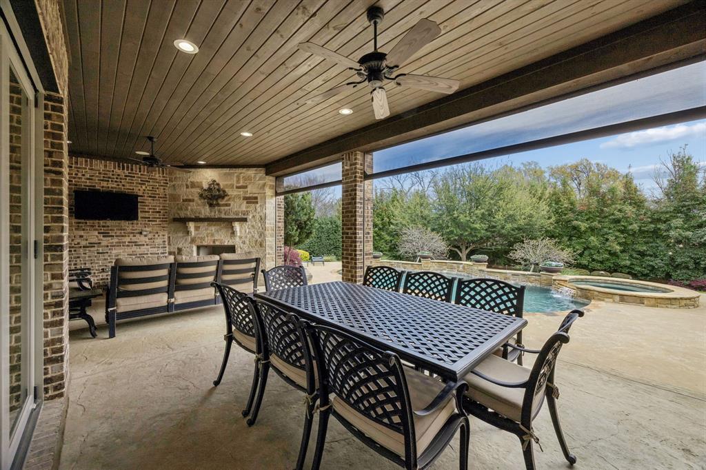 1005 Berkshire Road Southlake, TX 76092 - Photo 16 of 40 a view of a patio with a table chairs and a wooden roof