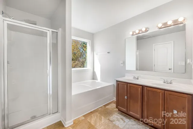 a bathroom with a tub sink and mirror