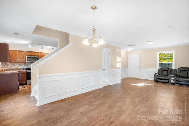 a view of a livingroom with furniture wooden floor and window