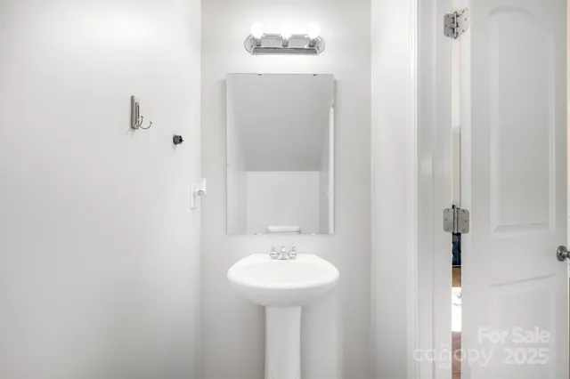 a bathroom with a sink a mirror and a toilet