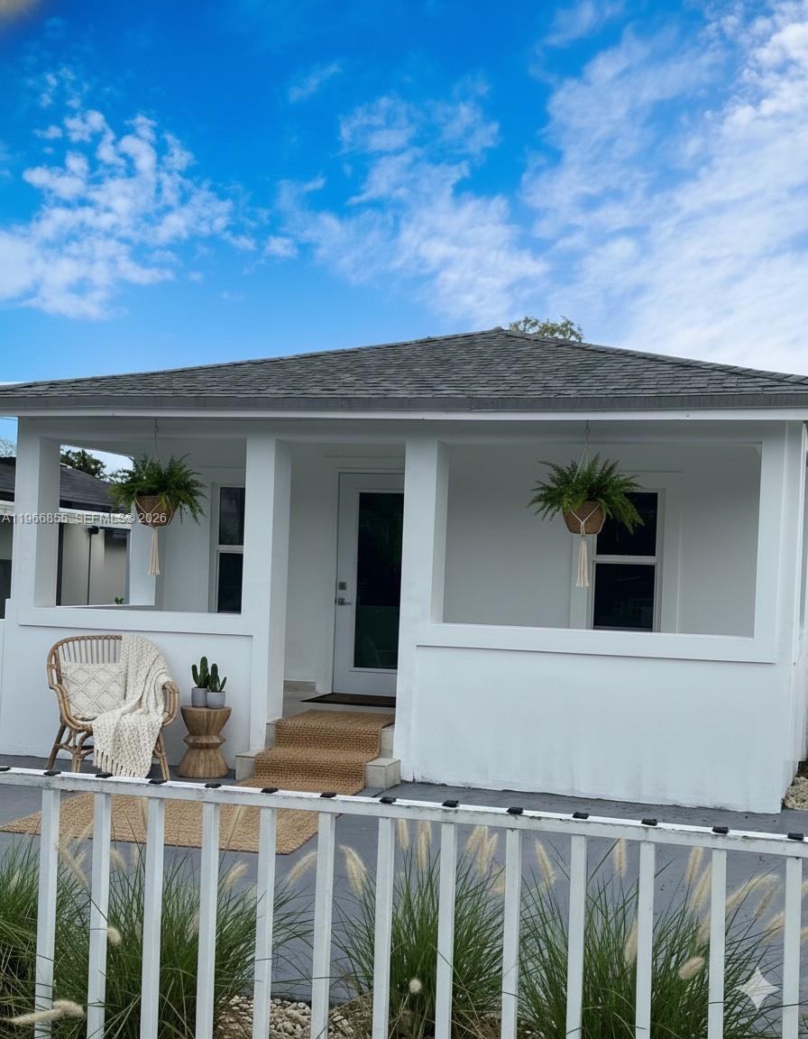 81 Northwest 44th Street, Unit 2 Miami, FL 33127 - Photo 1 of 6 a view of a house with wooden fence