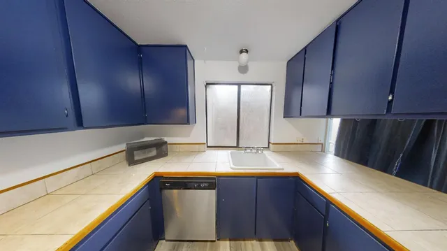 a view of a tennis ground with large trees