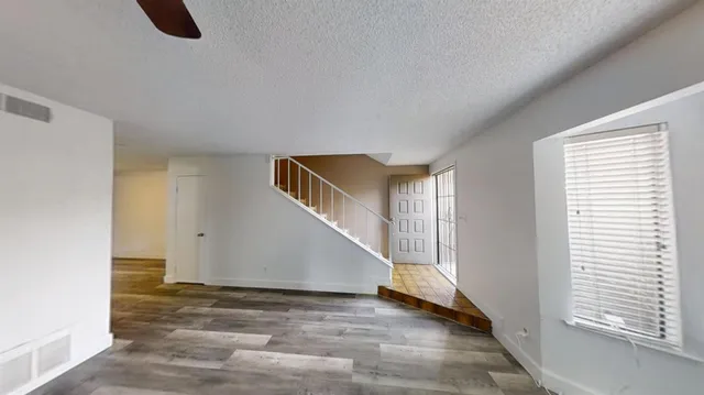 a view of an empty room with window and fire place