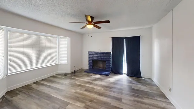 a kitchen with kitchen island granite countertop wooden cabinets a sink a stove and a refrigerator