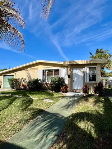 a view of a house with swimming pool and sitting area