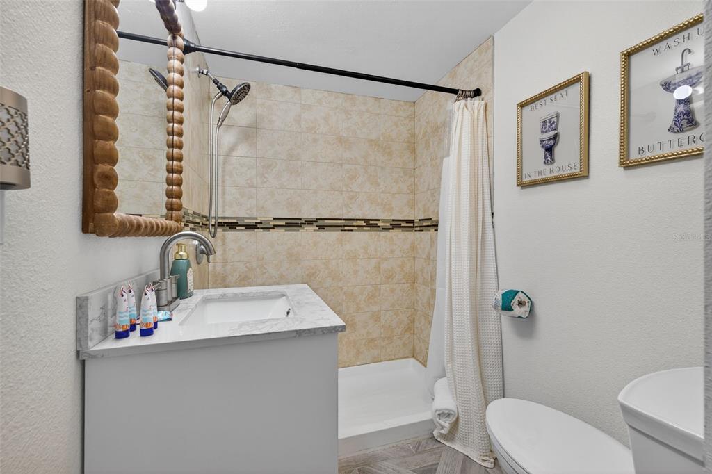14251 Gulf Boulevard, Unit 5 Madeira Beach, FL 33708 - Photo 15 of 18 a bathroom with a sink toilet and shower