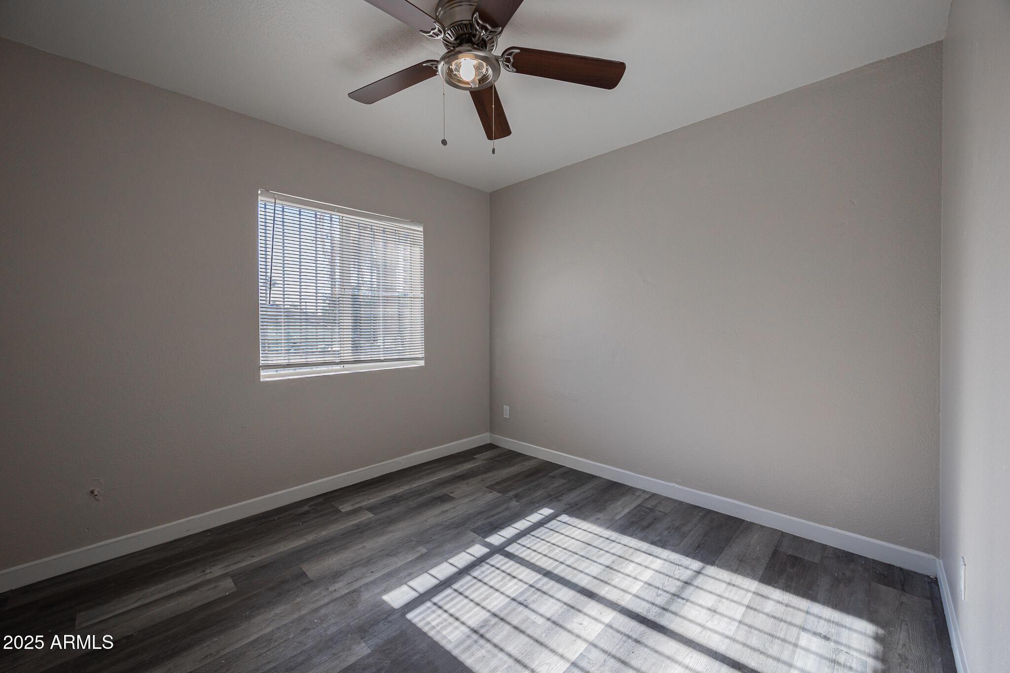 1703 West Mountain View Road, Unit 1 Phoenix, AZ 85021 - Photo 12 of 13 a view of an empty room with a window