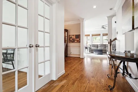 an empty room with wooden floor and a fireplace