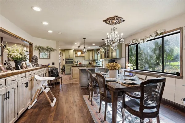 a kitchen with kitchen island granite countertop a sink cabinets and stainless steel appliances