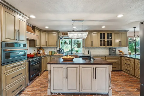 a kitchen with a sink appliances and cabinets