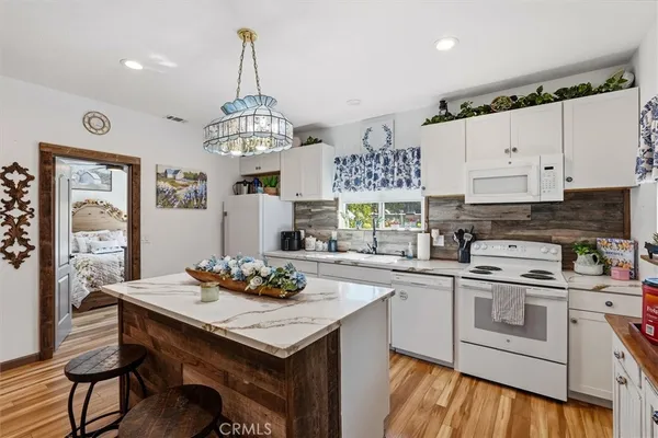 a view of a patio with couches chairs and potted plants