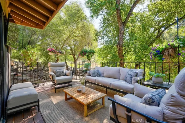 a balcony with furniture and a potted plant