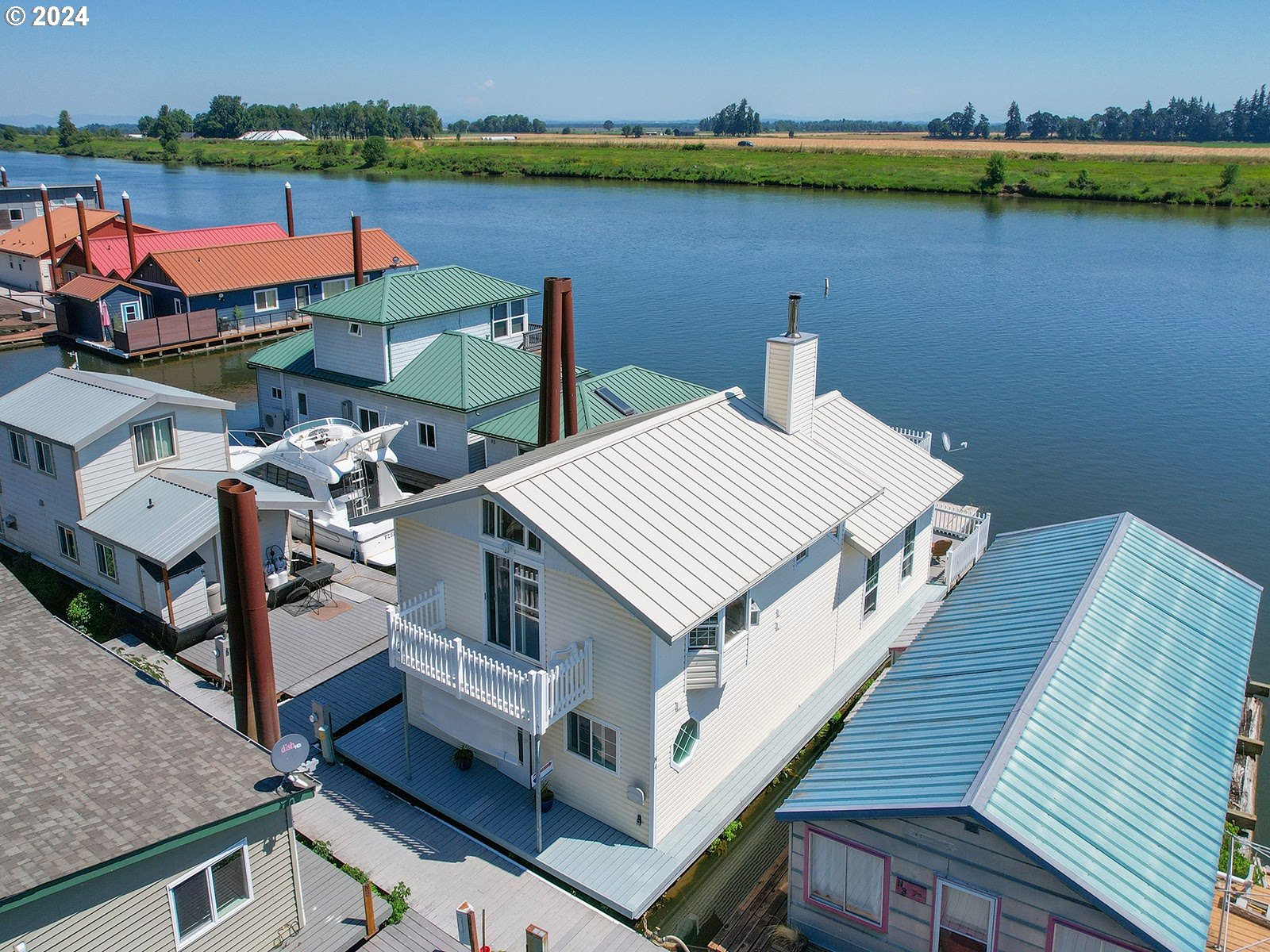 an aerial view of a house with swimming pool and lake view