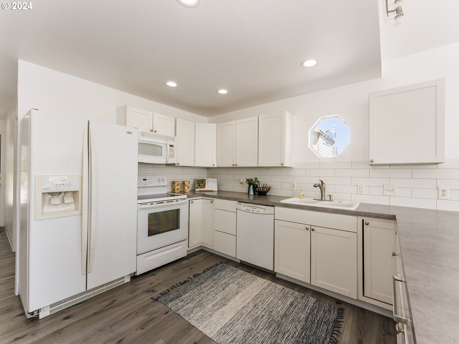 23560 Northwest St Helens Road, Unit N4 Portland, OR 97231 - Photo 12 of 37 a kitchen with white cabinets and white appliances