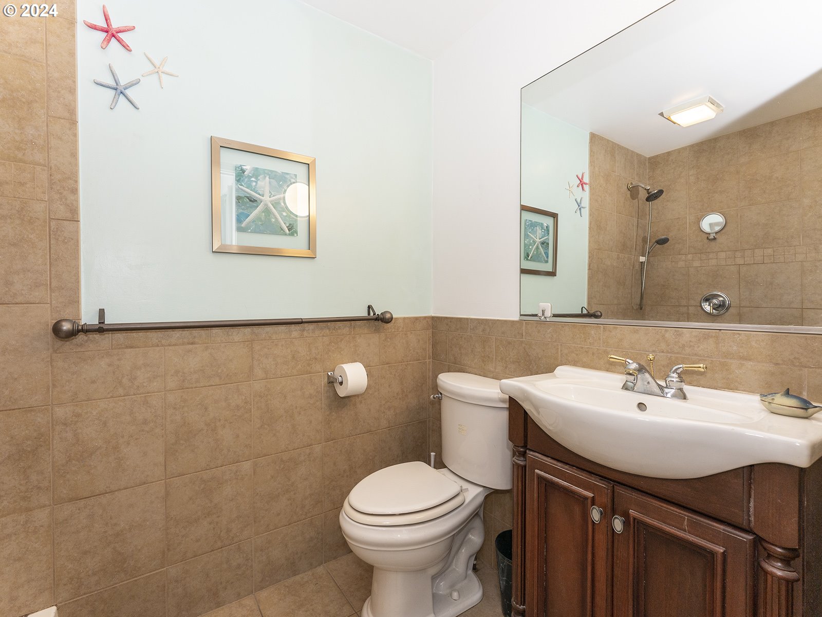 23560 Northwest St Helens Road, Unit N4 Portland, OR 97231 - Photo 20 of 37 a bathroom with a sink mirror and toilet