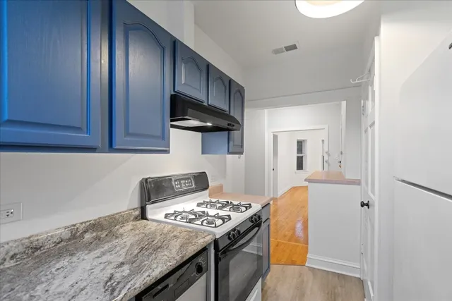 a kitchen with a stove and a refrigerator