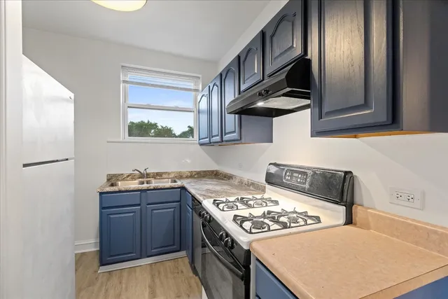 a kitchen with stainless steel appliances granite countertop a stove a sink dishwasher and refrigerator