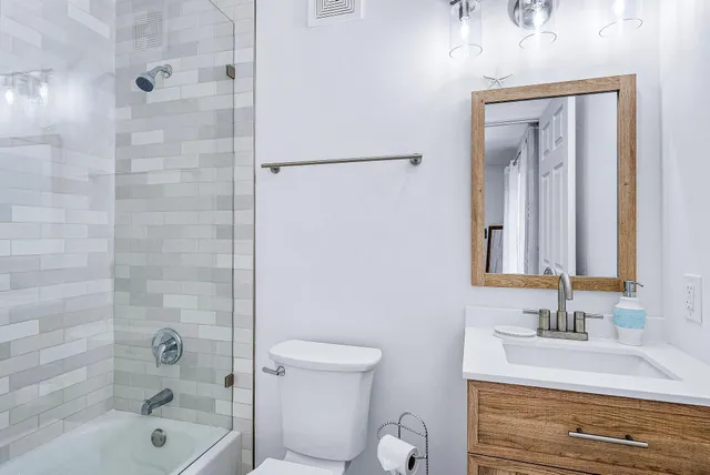 a bathroom with a toilet a sink and mirror