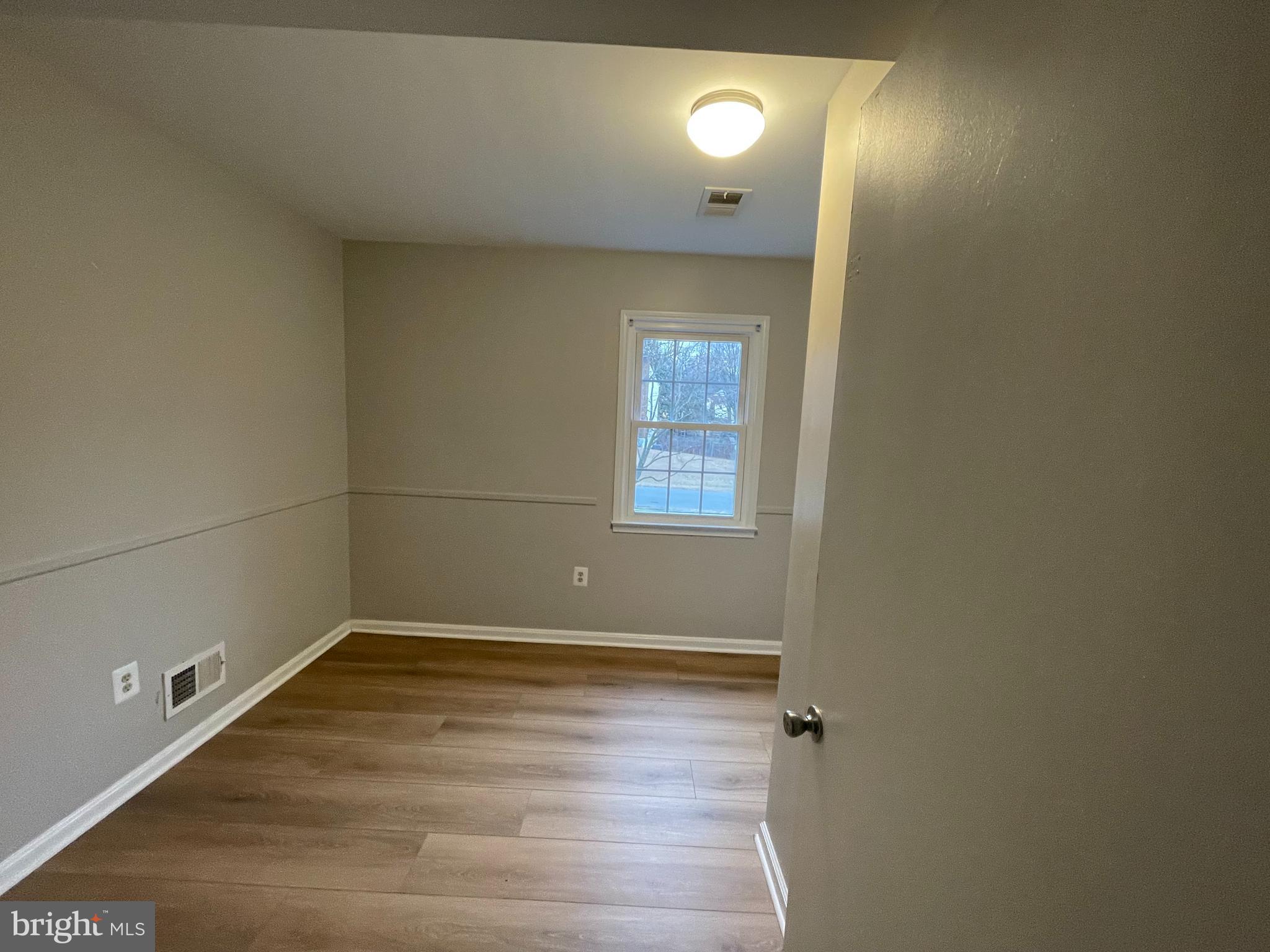 7004 Wick Lane Derwood, MD 20855 - Photo 13 of 19 a view of a room with wooden floor and windows