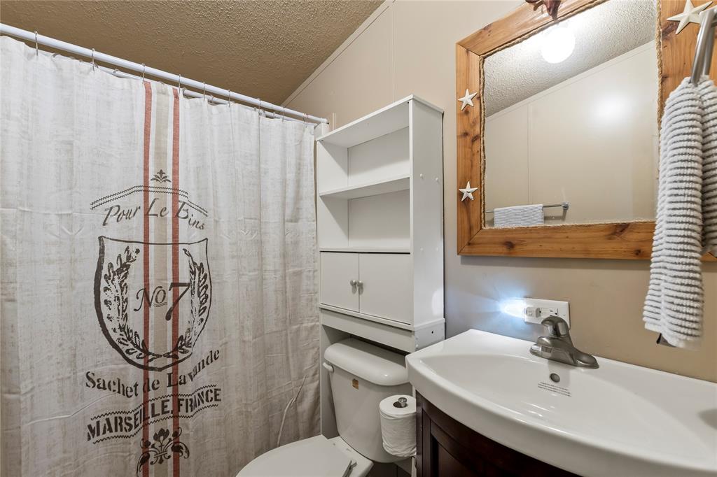 194 Indian Gap Road Mabank, TX 75156 - Photo 12 of 18 a bathroom with a sink toilet and shower
