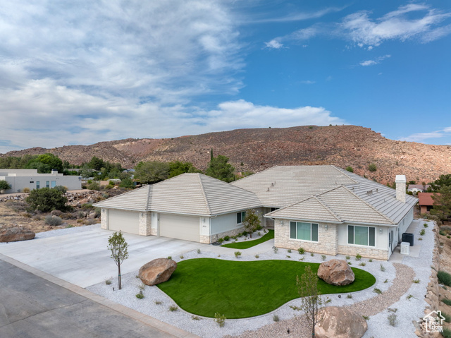 230 Boulder Way Leeds, UT 84746 - Photo 44 of 72 View of front of house with stone siding, a mountain view, and stucco siding, Low E Windows, artificial turf