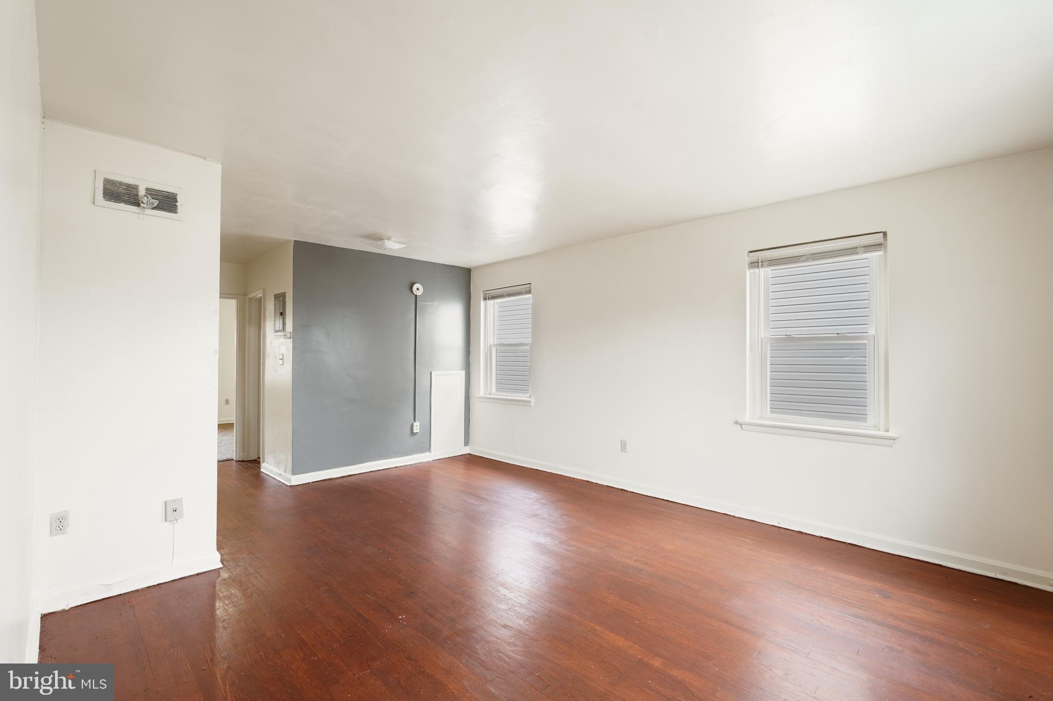2303 S Street Southeast Washington, DC 20020 - Photo 12 of 18 an empty room with wooden floor and windows