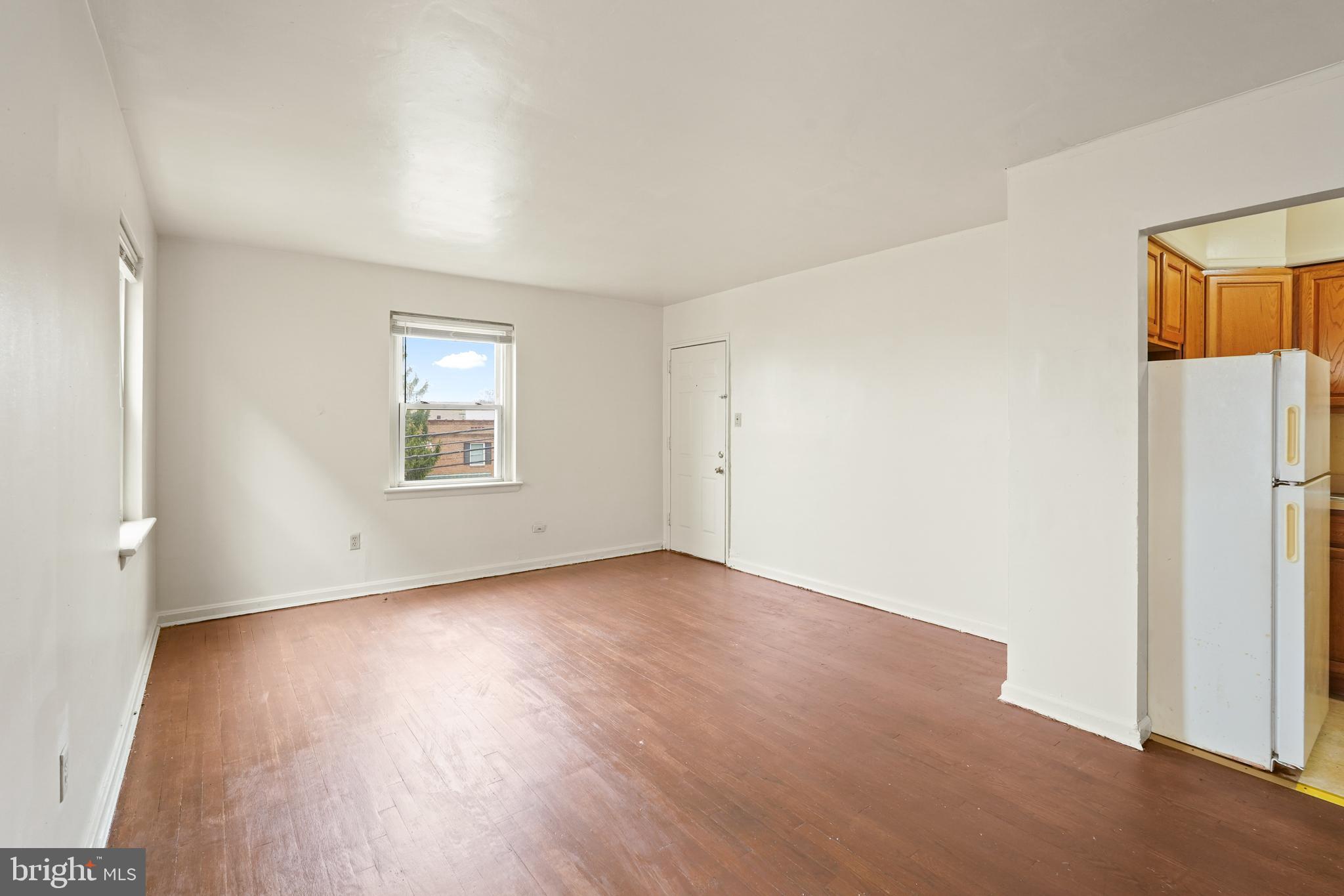 2303 S Street Southeast Washington, DC 20020 - Photo 13 of 18 an empty room with a wooden floor and a window