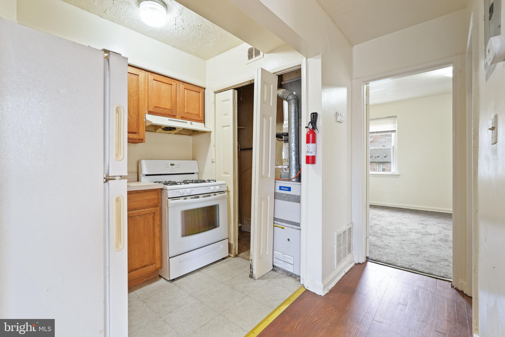 2303 S Street Southeast Washington, DC 20020 - Photo 14 of 18 a view of kitchen with stainless steel appliances granite countertop a refrigerator and a stove top oven