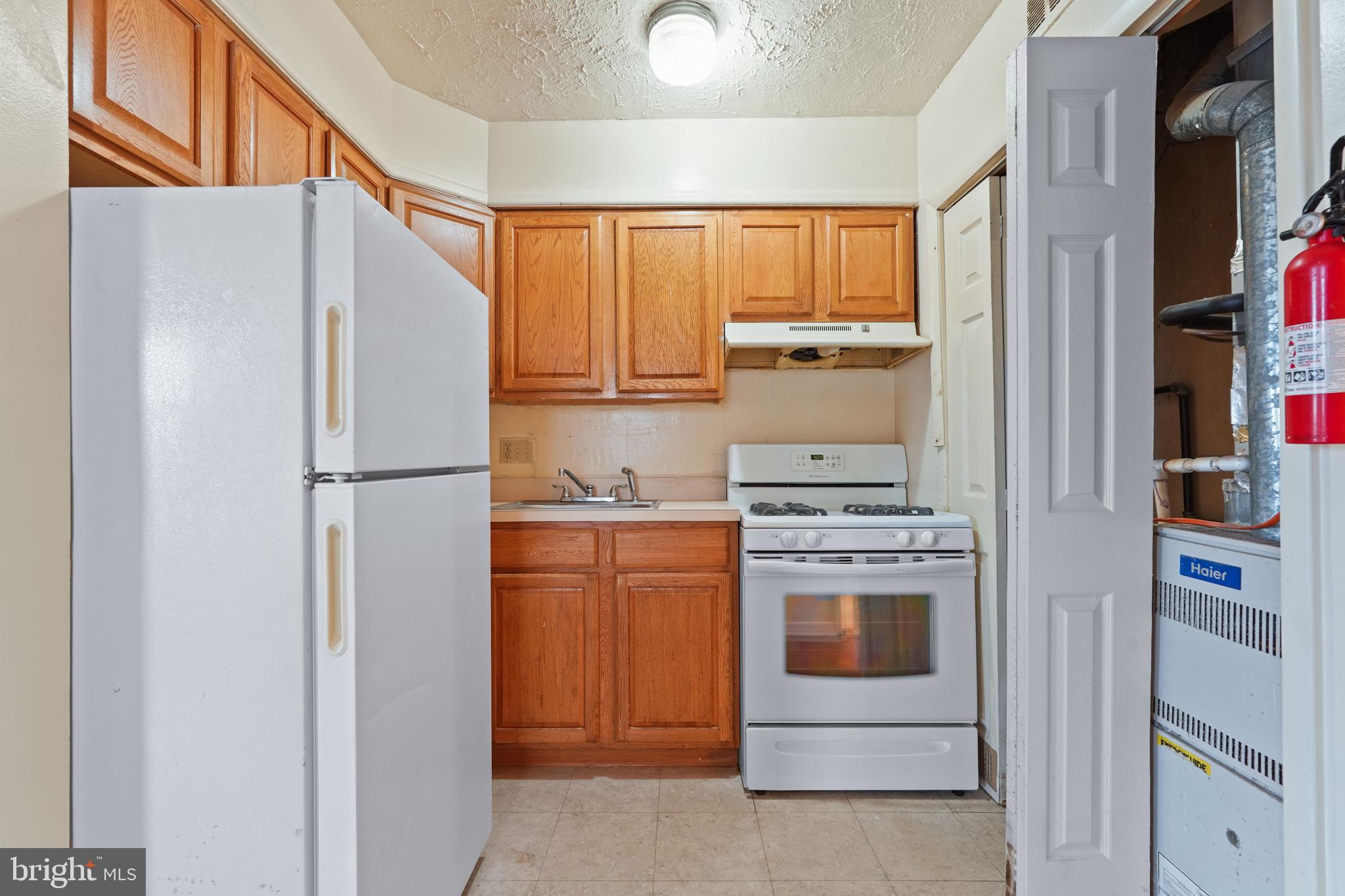 2303 S Street Southeast Washington, DC 20020 - Photo 15 of 18 a kitchen with stainless steel appliances granite countertop a refrigerator and a stove