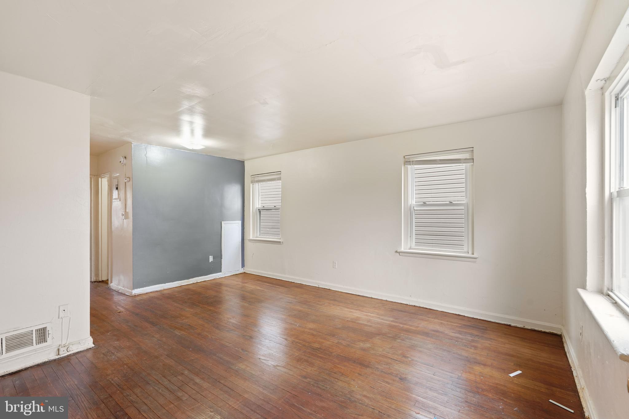 2303 S Street Southeast Washington, DC 20020 - Photo 3 of 18 an empty room with wooden floor and windows