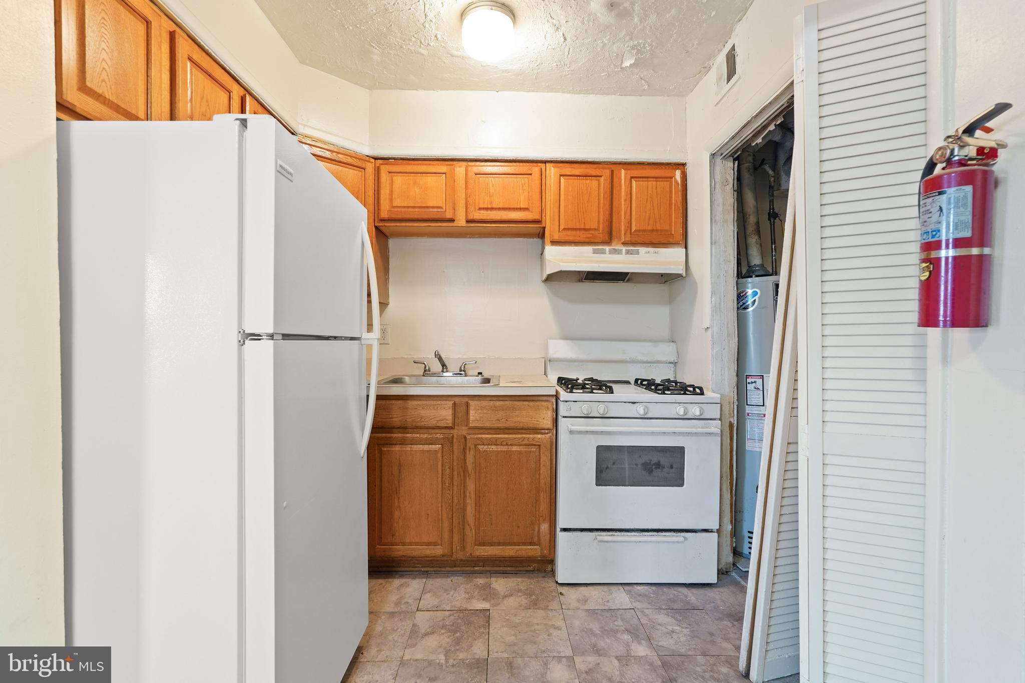 2303 S Street Southeast Washington, DC 20020 - Photo 6 of 18 a kitchen with stainless steel appliances granite countertop a refrigerator and a stove