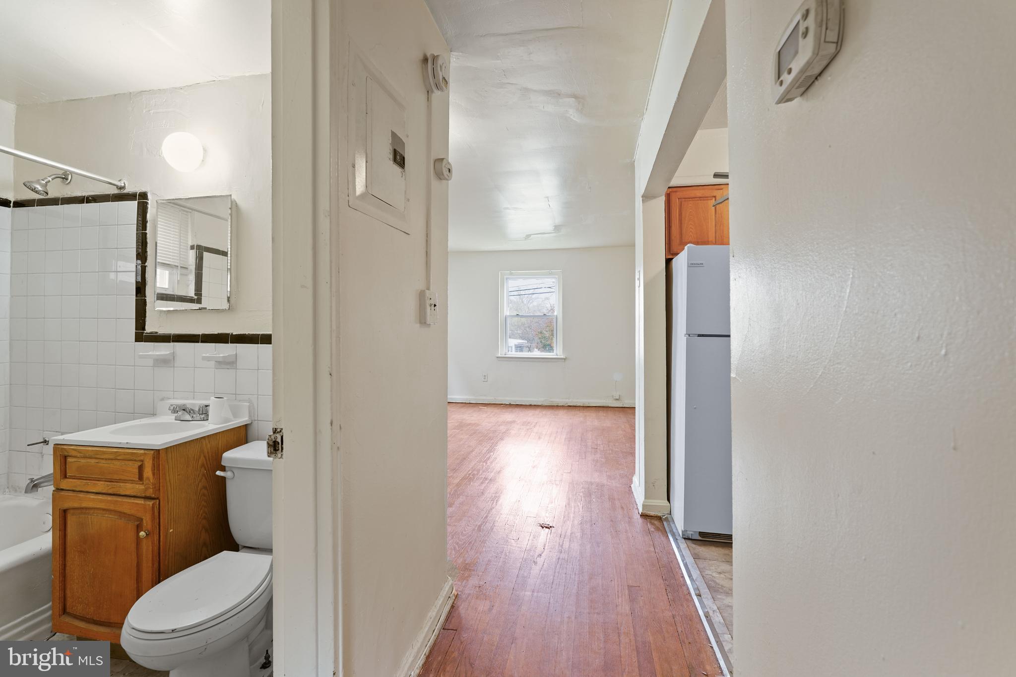 2303 S Street Southeast Washington, DC 20020 - Photo 7 of 18 a bathroom with a toilet a sink and wooden floor