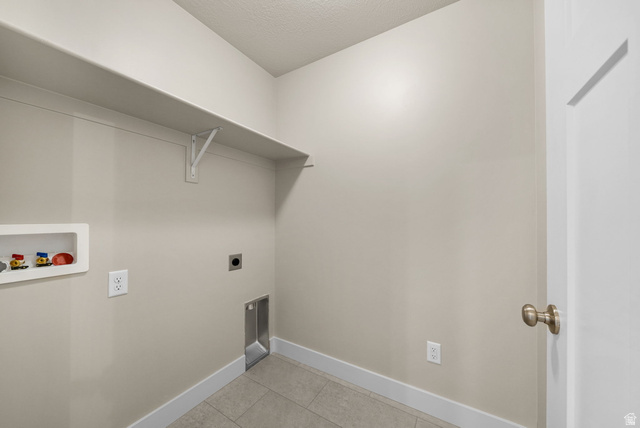 175 West 930 North Santaquin, UT 84655 - Photo 19 of 22 Utility space featuring neutral wall tones, durable tile flooring, and a built-in wall shelf
