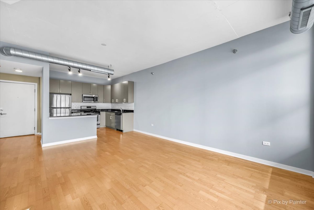 909 West Washington Boulevard, Unit 803 Chicago, IL 60607 - Photo 8 of 21 a view of kitchen with kitchen island and stainless steel appliances