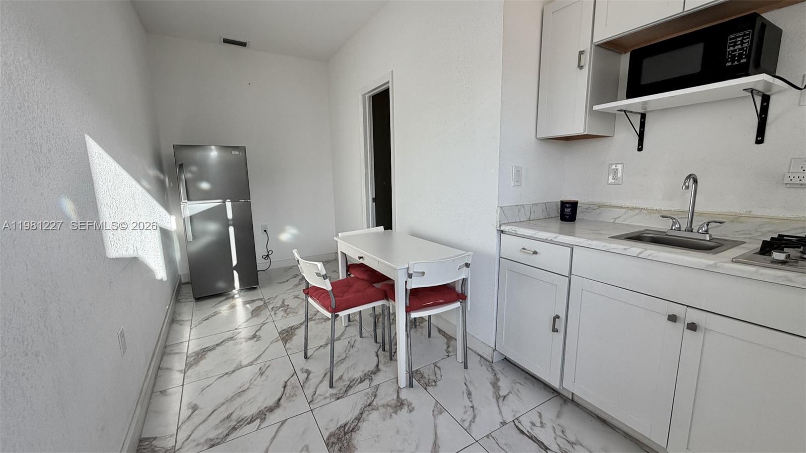 a spacious bathroom with a sink and a mirror