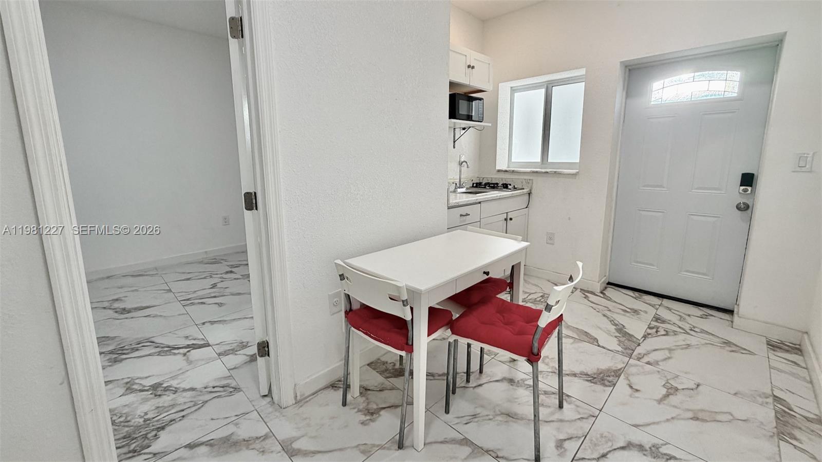 12435 Southwest 42nd Street, Unit 2 Miami, FL 33175 - Photo 2 of 8 a view of a bathroom with a sink and a mirror