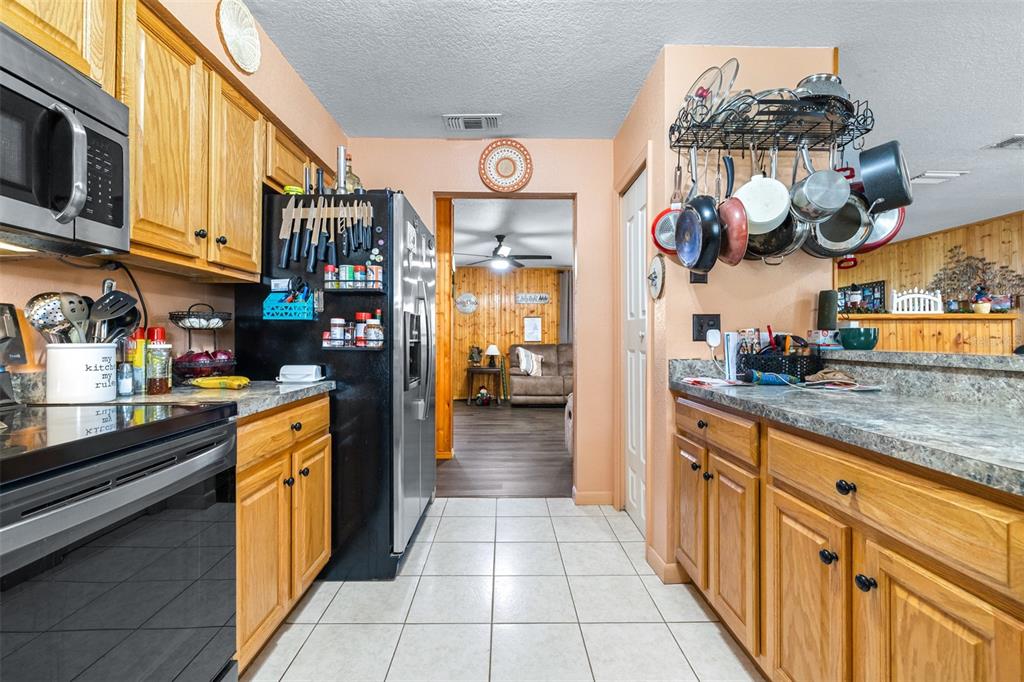 1645 County Road 630 Frostproof, FL 33843 - Photo 15 of 76 a kitchen with stainless steel appliances granite countertop a lot of counter top space and wooden floor