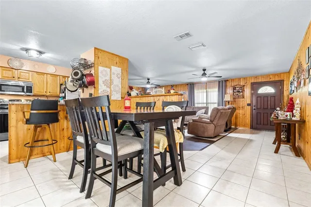 a dining room with furniture and a window
