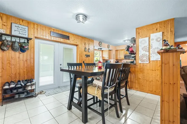 a bedroom with a bed and a flat tv screen on dresser