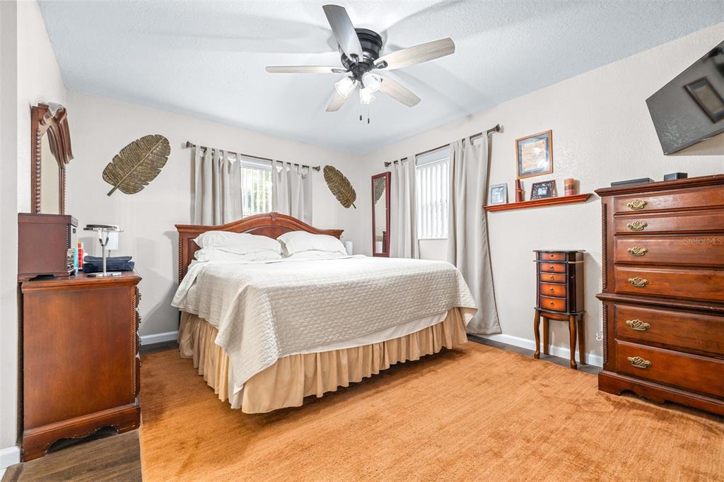 1645 County Road 630 Frostproof, FL 33843 - Photo 20 of 76 a bedroom with a bed and a flat tv screen on dresser