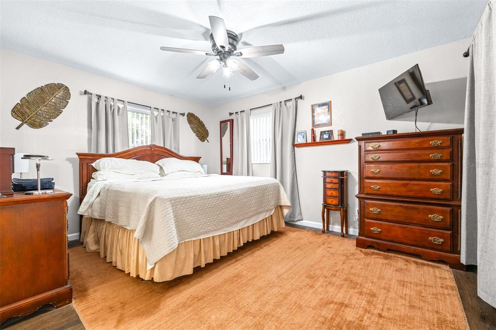 1645 County Road 630 Frostproof, FL 33843 - Photo 21 of 76 a bedroom with a bed and a flat tv screen on the dresser
