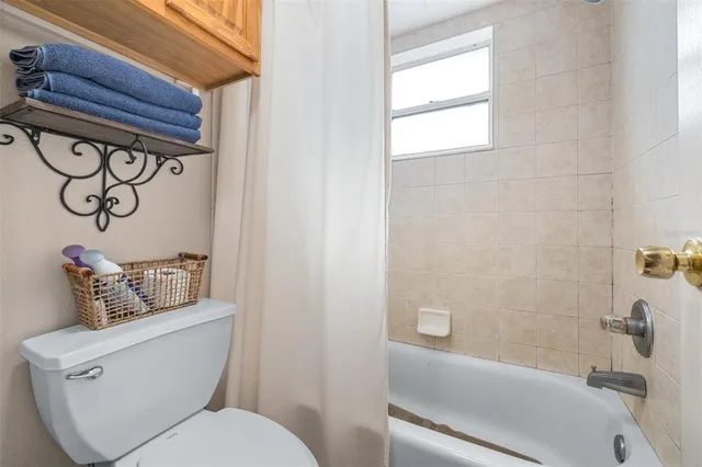 a view of a bedroom with workspace and a window