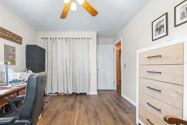 a view of a livingroom with wooden floor and furniture