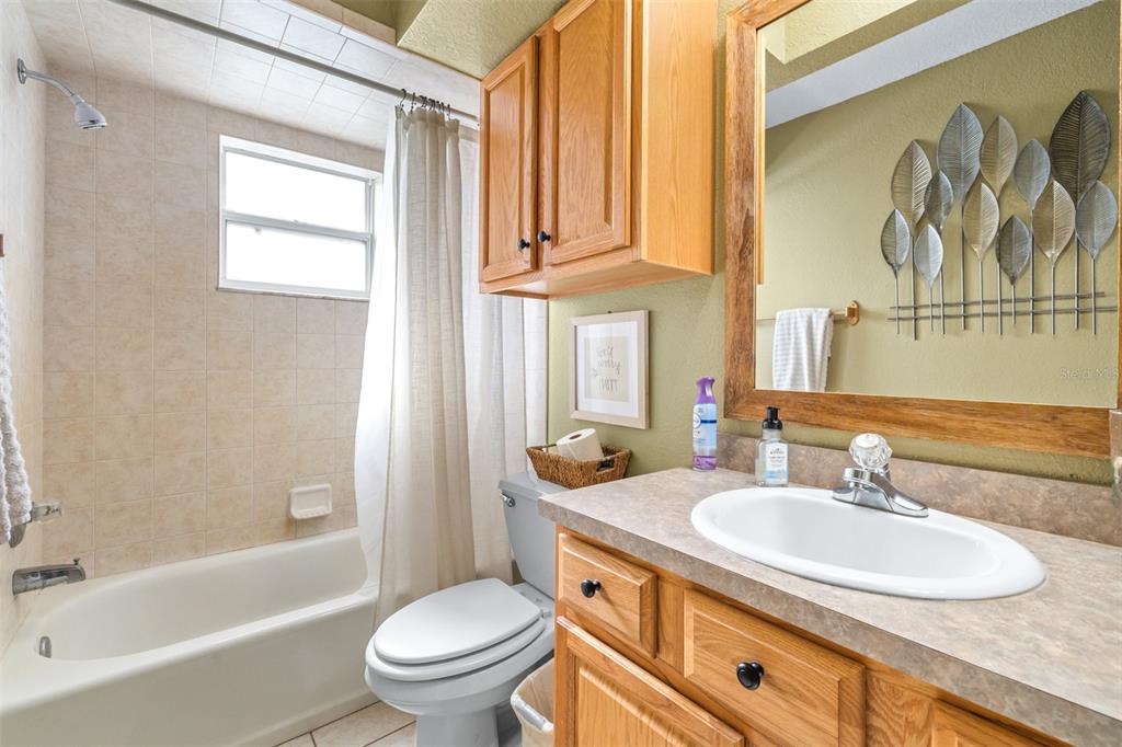 1645 County Road 630 Frostproof, FL 33843 - Photo 29 of 76 a bathroom with a granite countertop sink toilet and a bathtub