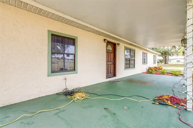 a view of a porch with a floor to ceiling window