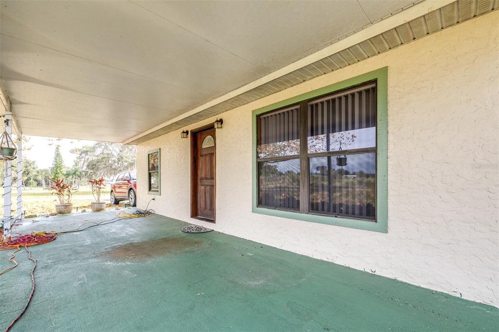 1645 County Road 630 Frostproof, FL 33843 - Photo 4 of 76 a view of a porch with a floor to ceiling window