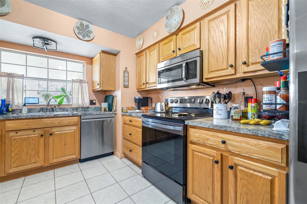 1645 County Road 630 Frostproof, FL 33843 - Photo 8 of 76 a kitchen with stainless steel appliances granite countertop a sink and cabinets